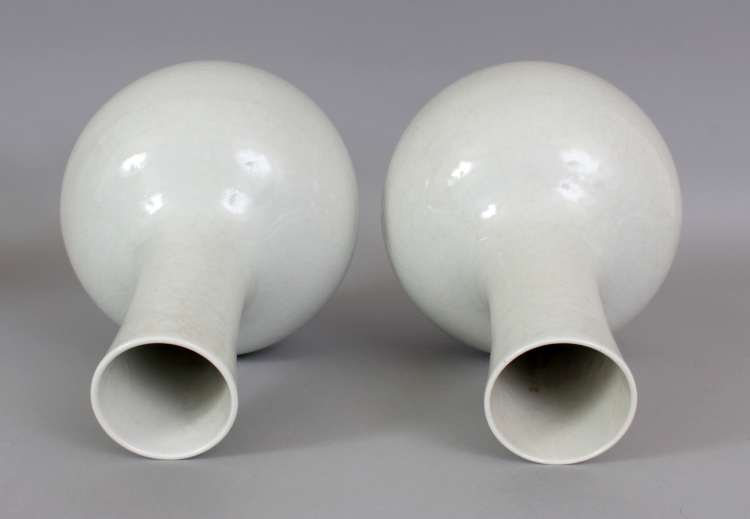 A PAIR OF 18TH/19TH CENTURY CHINESE WHITE GLAZED PORCELAIN BOTTLE VASES, each decorated in white - Image 4 of 8