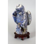 AN 18TH/19TH CENTURY CHINESE CARVED LAPIS MODEL OF A HAWK, together with a fitted carved hardwood