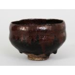 A JAPANESE RAKU CHAWAN POTTERY TEA BOWL SIGNED GENNYU, 18th Century or later, the sides applied a