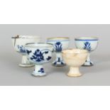 A GROUP OF FIVE SMALL CHINESE PORCELAIN STEM BOWLS, mostly early 18th Century and mostly blue and