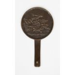 A JAPANESE BRONZE HAND MIRROR, possibly early, one side cast in relief with a stork in flight over