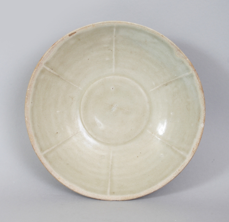 A CHINESE SONG DYNASTY PORCELAIN BOWL, possibly Yue ware, of rounded conical form, the interior with