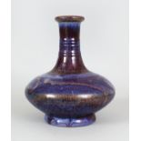 A GOOD 19TH CENTURY CHINESE FLAMBE GLAZED PORCELAIN VASE, of compressed bottle form, the sides