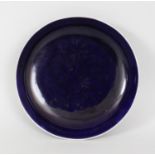 A CHINESE QIANLONG MARK & PERIOD AUBERGINE GLAZED PORCELAIN DRAGON DISH, of saucer shape and