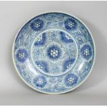 AN 18TH/19TH CENTURY CHINESE PROVINCIAL PORCELAIN DISH, of saucer shape, painted with stylised