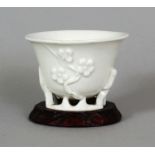 A SIMILAR 17TH/18TH CENTURY CHINESE DEHUA BLANC-DE-CHINE PORCELAIN LIBATION CUP, of near circular