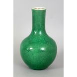 AN 18TH CENTURY CHINESE APPLE GREEN CRACKLEGLAZE PORCELAIN BOTTLE VASE, the sides and base applied