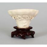 A 17TH/18TH CENTURY CHINESE DEHUA BLANC-DE-CHINE MOULDED PORCELAIN LIBATION CUP, of rhinoceros