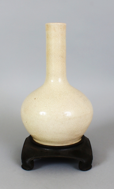 A CHINESE WHITE GLAZED PORCELAIN BOTTLE VASE, possibly Ming Dynasty, together with a fitted wood