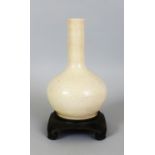 A CHINESE WHITE GLAZED PORCELAIN BOTTLE VASE, possibly Ming Dynasty, together with a fitted wood