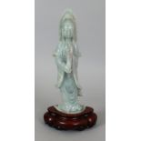 A CHINESE CELADON GREEN JADE FIGURE OF GUANYIN, together with a fitted wood stand, 13.5in(34.3cm)