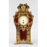 AN ART NOUVEAU UPRIGHT CLOCK, mahogany case with gilt metal mounts and scrolls. 17ins high.