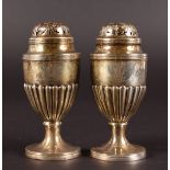 A PAIR OF VICTORIAN PEDESTAL PEPPERETTES. London 1895. Engraved with Prince of Wales Plumes.