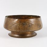 A LARGE ART NOUVEAU COPPER CIRCULAR BOWL, the sides repousse with four devils masks, 11ins