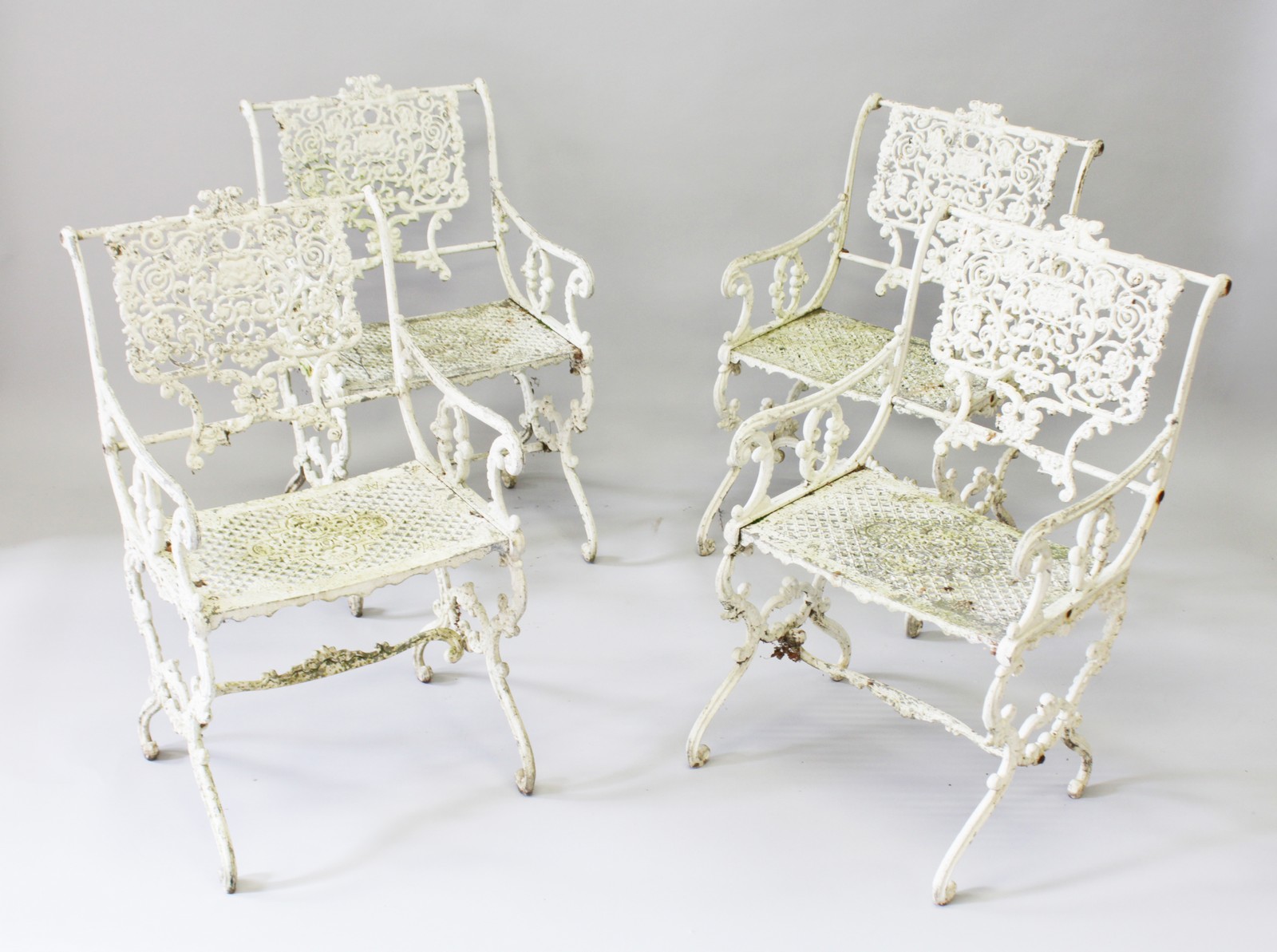 A SET OF FOUR PAINTED IRON GARDEN ARMCHAIRS.