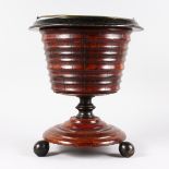 A DUTCH MAHOGANY CIRCULAR BUCKET ON STAND with brass liner and handle. 1ft 4ins high.