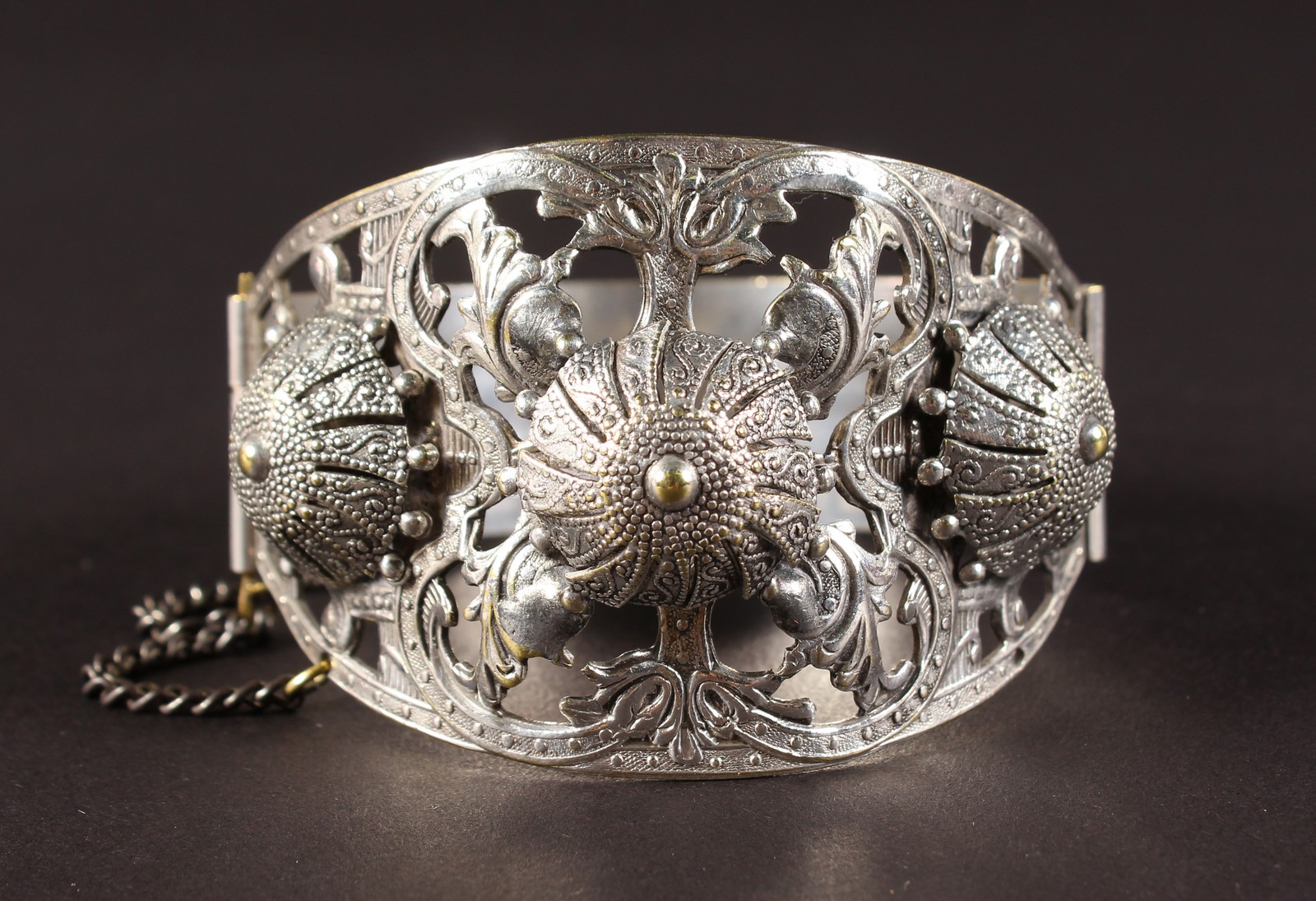 AN ALGERIAN PIERCED SILVER BANGLE with star inside crescent moon mark.