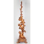 A SUPERB 18TH-19TH CENTURY ITALIAN CARVED WALNUT STANDARD LAMP with three cupids climbing a tree, on