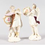 A SMALL PAIR OF CONTINENTAL PORCELAIN WINGED FIGURES carrying plaques. 12ins high.