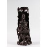 A SMALL CARVED CHINESE ROSEWOOD GUANYIN. 1ft 6ins high.
