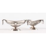 A SMALL PAIR OF BOAT SHAPED SILVER SALTS.