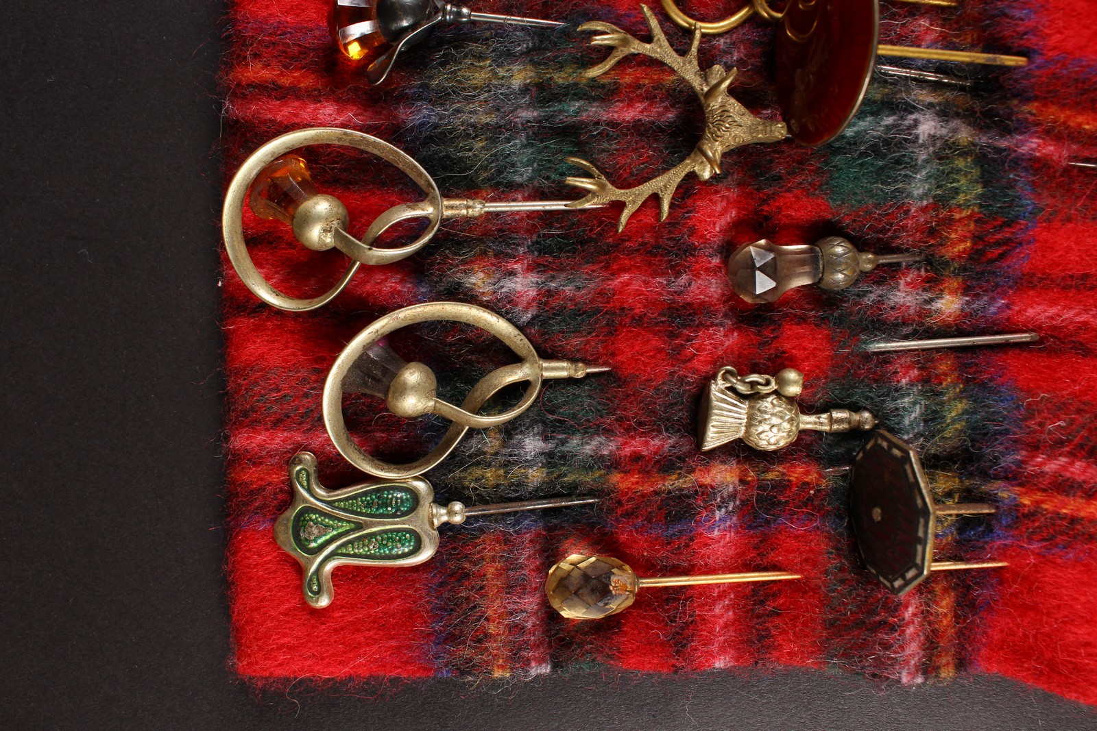 A COLLECTION OF SEVENTEEN VICTORIAN AND EDWARDIAN HAT PINS on a tartan cloth. - Image 2 of 4