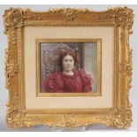 A KPM PORCELAIN GILT FRAMED PLAQUE of A YOUNG LADY, HALF LENGTH SITTING IN A CHAIR. Impressed