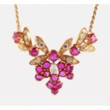 AN 18CT YELLOW GOLD, RUBY AND DIAMOND SET FLORAL NECKLACE.