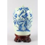 A CHINESE BLUE AND WHITE GINGER JAR AND COVER with birds and flowers on a wooden stand. 12ins high.