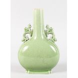 A GREEN GLAZE PILGRIM BOTTLE. 9ins high.