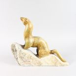 W. A. CAMERON (20TH CENTURY) CANADIAN A SOAPSTONE CARVING OF A MINK, carved in British Columbia,
