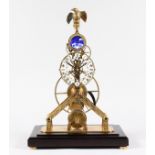 A GOOD BRASS SKELETON CLOCK with eagle top. 1ft 9ins high, in a glass case.