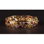 A 14CT YELLOW GOLD MULTI GEMSTONE BANGLE, set with garnets, topaz, tourmaline, peridot and