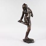 AFTER EDGAR DEGAS A GOOD BRONZE OF A NUDE DANCER looking at her foot. Signed Degas, foundry stamp.