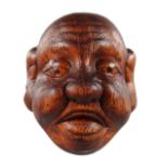 A CHINESE CARVED WOOD NETSUKE, Mask.