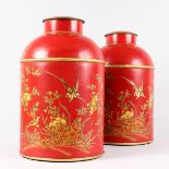 A PAIR OF RED TOLEWARE CIRCULAR JARS AND COVERS with Chinese decoration. 1ft 2ins high.