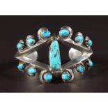 A SILVER BRACELET with turquoise stones.