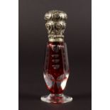 A VICTORIAN CUT GLASS RUBY SCENT BOTTLE with silver top.