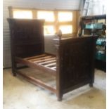 A JACOBEAN REVIVAL CARVED OAK TESTER STYLE BED FRAME.