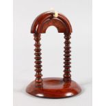 A GOOD ROSEWOOD WATCH STAND with turned supports. 5.5ins high.