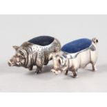 TWO SMALL SILVER NOVELTY PIG PIN CUSHIONS.