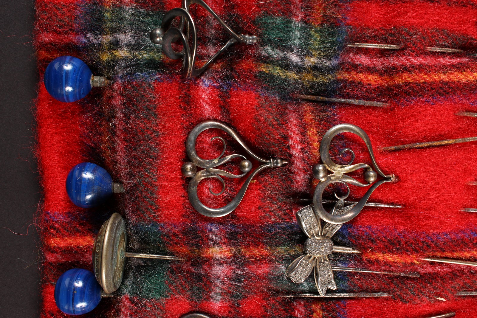 A COLLECTION OF FOURTEEN VICTORIAN AND EDWARDIAN HAT PINS on a tartan cloth. - Image 3 of 4