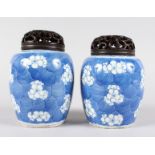 A SMALL PAIR OF CHINESE BLUE & WHITE GINGER JARS with pierced wooden stoppers. 6ins high.