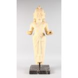 A GOOD THAI CARVED WHITE MARBLE STANDING FEMALE FIGURE, 30ins high, on a black veined marble base.