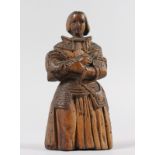 AN EARLY 18TH CENTURY CARVED FLAT BACK FIGURE OF A SAINT, arms crossed. 7ins long.