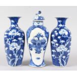 A SMALL PAIR OF CHINESE BLUE & WHITE VASES with prunus decoration, 8ins high, and a similar vase