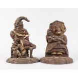 A GOOD PAIR OF PARTLY PAINTED CAST IRON PUNCH AND JUDY DOOR STOPS. 12ins and 11ins high.