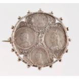 A VICTORIAN SILVER BROOCH set with four Maundy coins 1890.