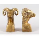 A PAIR OF BRASS RAM WEIGHT. 7ins high.