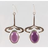 A PAIR OF SILVER MOUNTED AMETHYST ART NOUVEAU STYLE DROP EARRINGS.